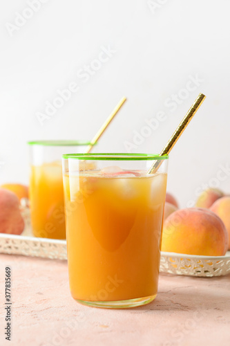 Glasses of fresh peach juice on table