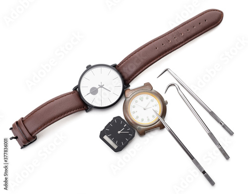Watches and tools for repair on white background
