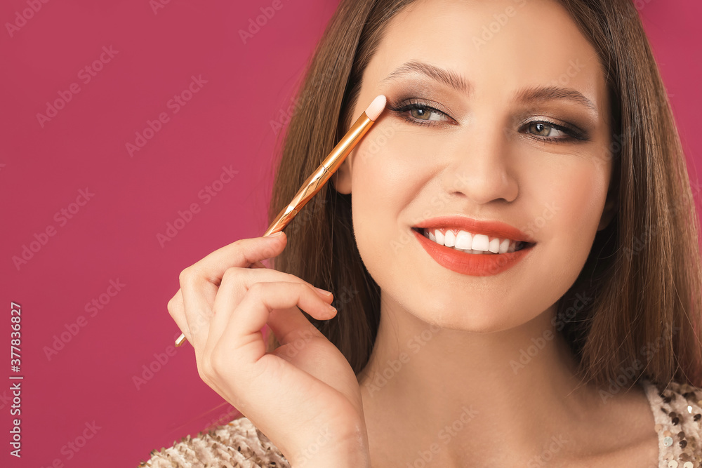 Young woman with beautiful eyeshadows on color background Young woman with beautiful eyeshadows on color background