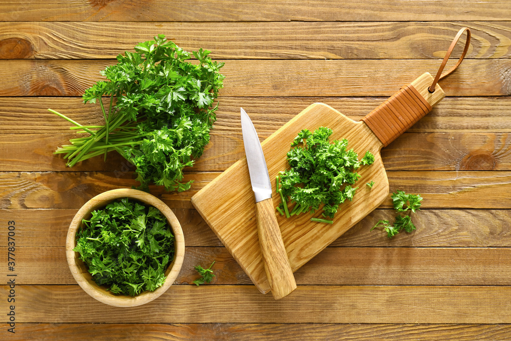 Composition with fresh parsley on wooden background