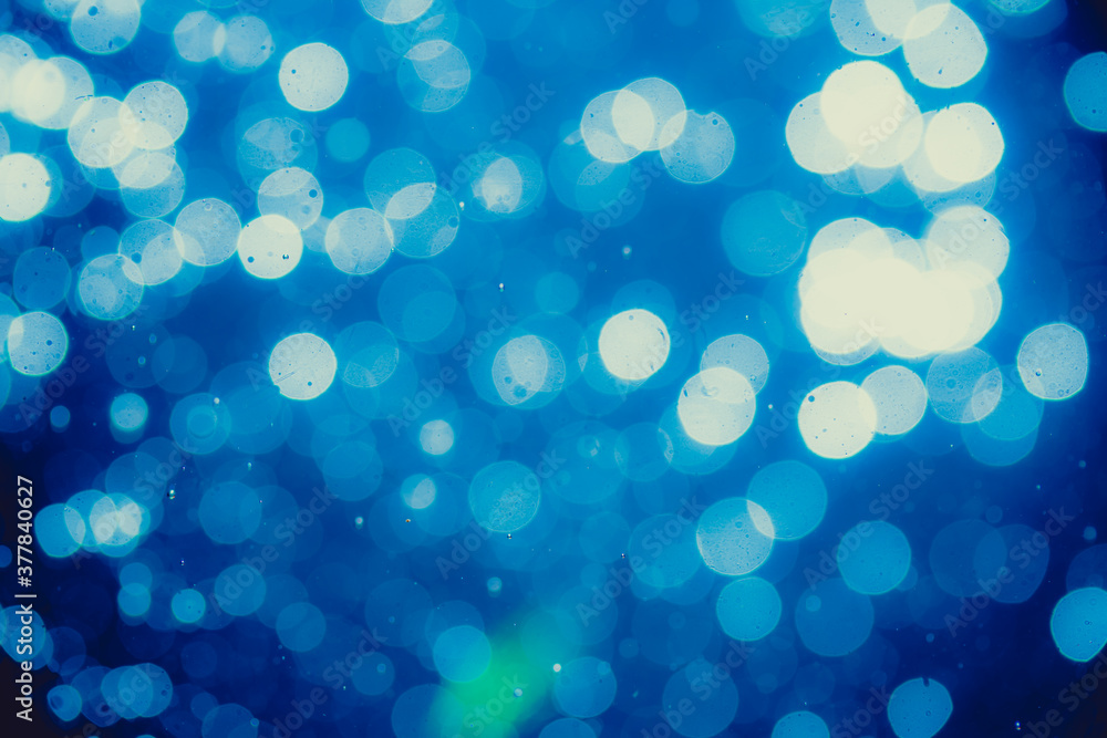 Abstract blue defocused bokeh of lights in dark Abstract blue defocused bokeh of lights in dark