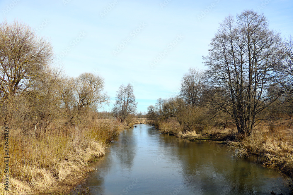 A small river flows on a clear autumn day. A small river flows on a clear autumn day.