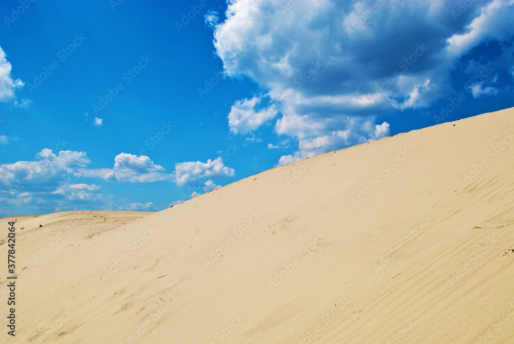 sand dunes with footprints and sky