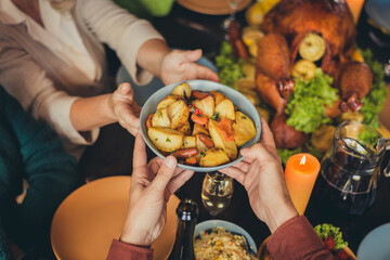 Cropped photo table arms share treat fried potato thanks giving dinner garnished turkey evening house living room indoors