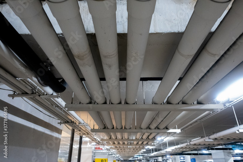Underground piping service system in an office building car parking delivering fresh water, sewage, electrical and gas to the offices and shop floors above