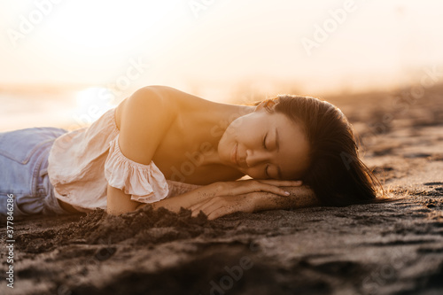 Smile Freedom and happiness chinese woman on beach. She is enjoying serene ocean nature during travel holidays vacation outdoors. asian beauty. summer time #377846286