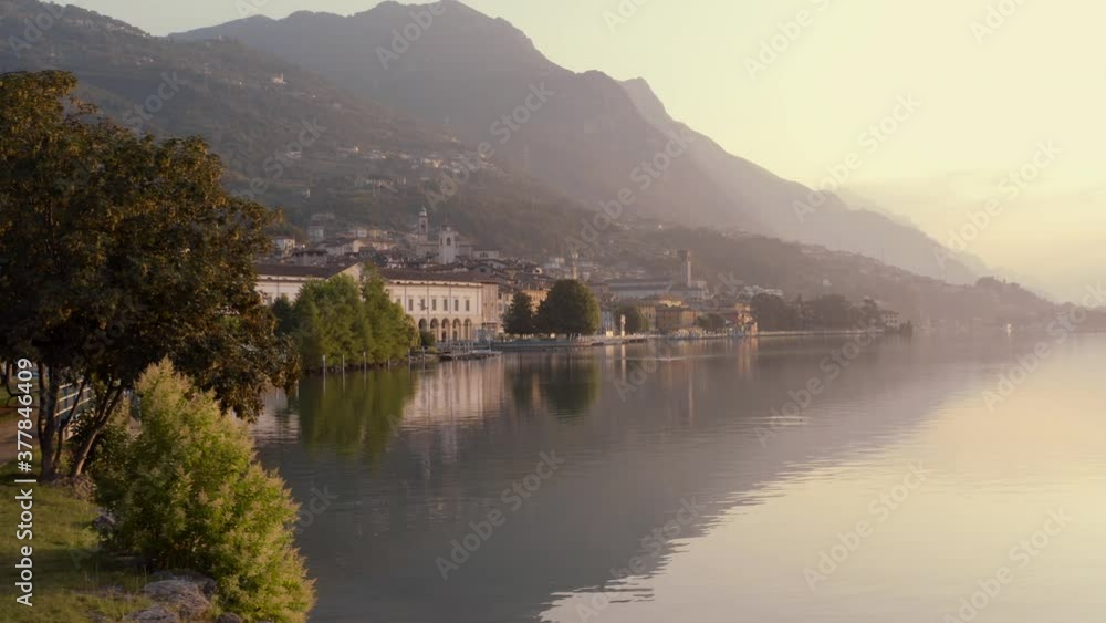 Drone view of Lake Iseo at sunrise, on the left the city of Lovere which runs along the lake,Bergamo Italy. Drone view of Lake Iseo at sunrise, on the left the city of Lovere which runs along the lake,Bergamo Italy.