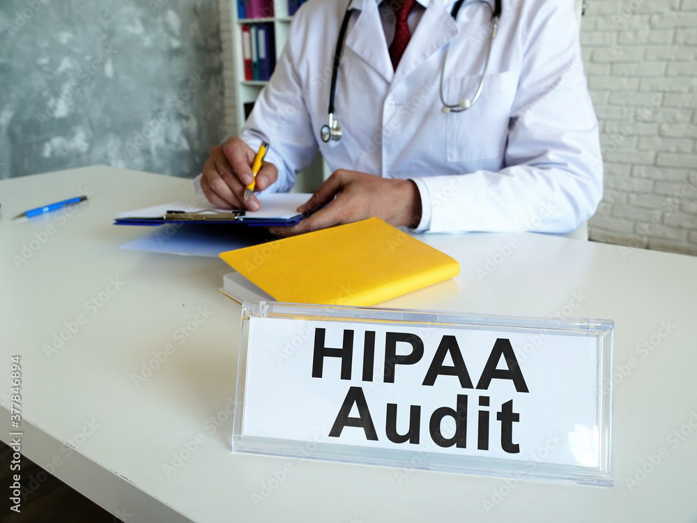 HIPAA audit concept. The doctor works with medical documents. HIPAA audit concept. The doctor works with medical documents.