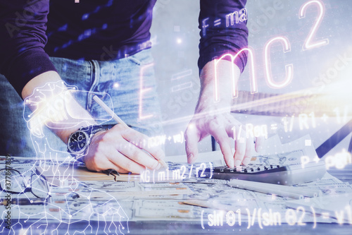 Photos Student or teacher with mathematical and scientific formulas