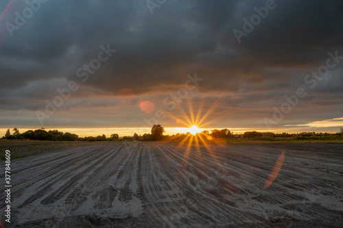 Sunshine and dark clouds over the field