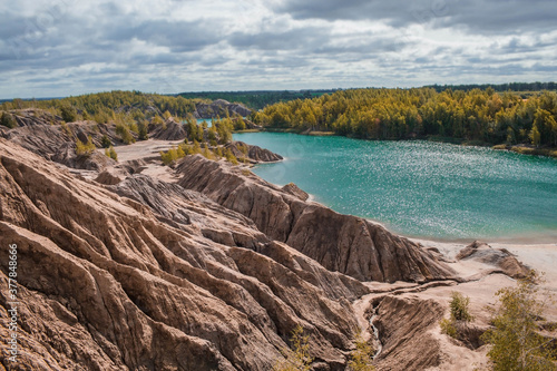 Konduki (Conduky) village, Tula region, Romancevskie mountains, Abandoned Ushakov quarries. Turquoise water lakes and the mud erosion of the soil looks like mountains. Beautiful natural landscape. photo