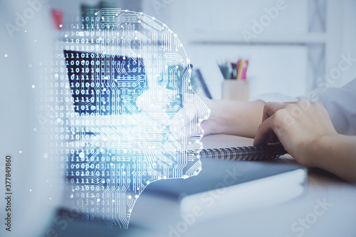 Multi exposure of writing hand on background with brain hologram. Concept of learning.