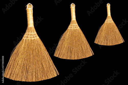 Three brooms isolated on a black background.  Space for lettering and design © Андрей Киселев