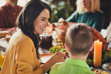 Full family thanksgiving holiday served table dinner chatting mom feed little son house evening living room indoors