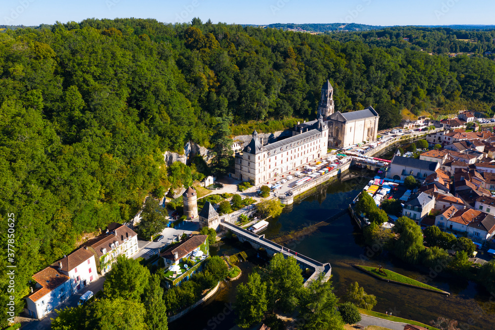 Picturesque aerial view of summer cityscape of Brantome en Perigord looking out over medieval abbey on banks of Dronne River, France..