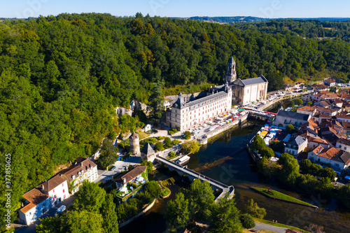 Picturesque aerial view of summer cityscape of Brantome en Perigord looking out over medieval abbey on banks of Dronne River, France..