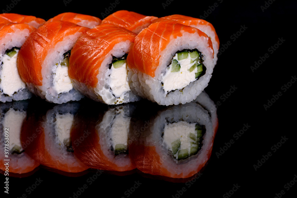 Fresh delicious beautiful sushi rolls on a dark background Fresh delicious beautiful sushi rolls on a dark background