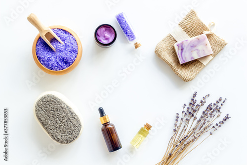 Lavender spa set. Violet bath salt and essence oil on white background