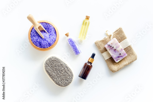 Lavender spa set. Violet bath salt and essence oil on white background