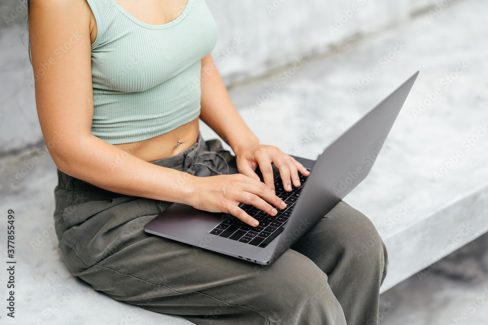 Naklejka premium Woman work freelance on laptop compute sitting at rocking chair in luxury villa on tropical island