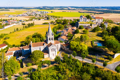 Drone view of medieval chateau and church in French village of Villebois-Lavalette on sunny summer day