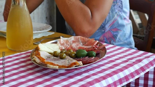 antipasto all'italiana, con porchetta, olive, salame e formaggio photo