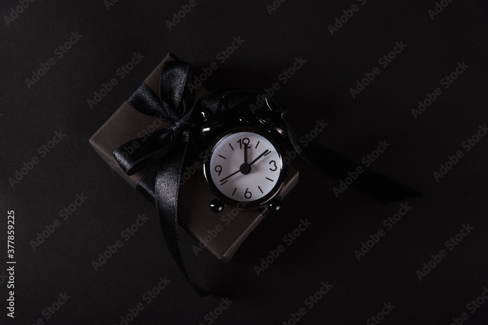 custom made wallpaper toronto digitalBlack Friday sale shopping concept, Top view of gift box wrapped in black paper and black bow ribbon and black alarm clock, studio shot on black background