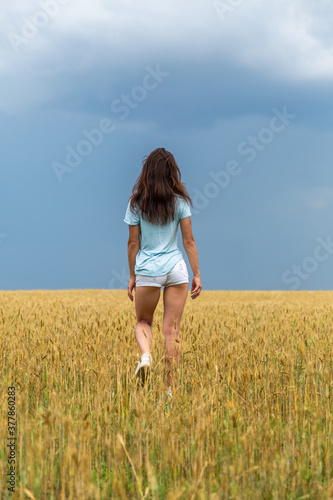 Young Woman In Wheat Field At Summer
