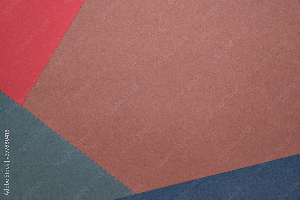 Three sheets of colored paper on a brown background. Red, green, blue. Minimalistic composition. Background for text or design. Empty right side. Top view Three sheets of colored paper on a brown background. Red, green, blue. Minimalistic composition. Background for text or design. Empty right side. Top view