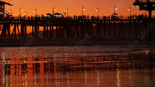 California summertime beach aesthetic, golden sunset. Vivid sky over pacific ocean waves. Santa Monica popular resort, Los Angeles CA USA. Famous pier against atmospheric moody evening sundown in LA