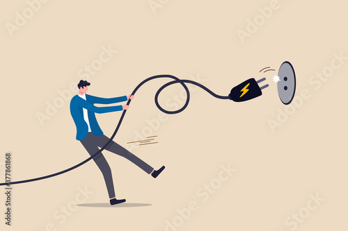 Electricity saving, ecology awareness or reduce electric cost and expense concept, man pulling electric cord to unplug to save money or for ecology power. photo