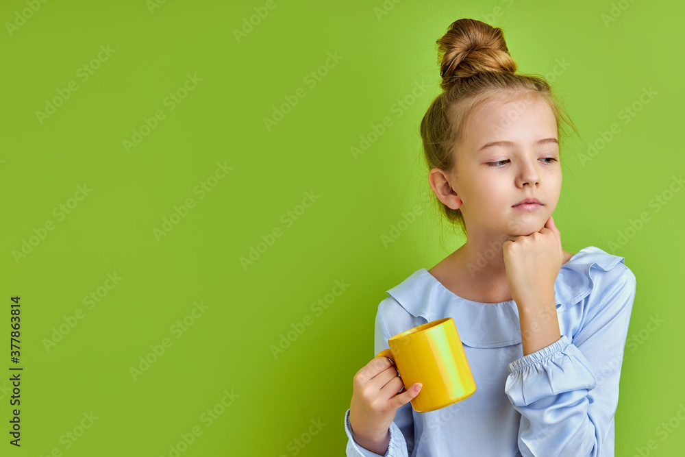 sleepy child girl has no enough sleep in the morning before school, she is holding a cup of coffee, tired sleepy child girl has no enough sleep in the morning before school, she is holding a cup of coffee, tired