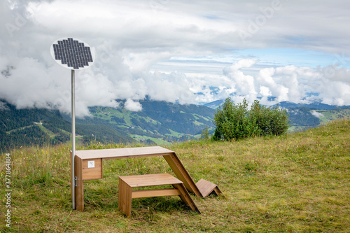 Table with solar panel in mountains photo