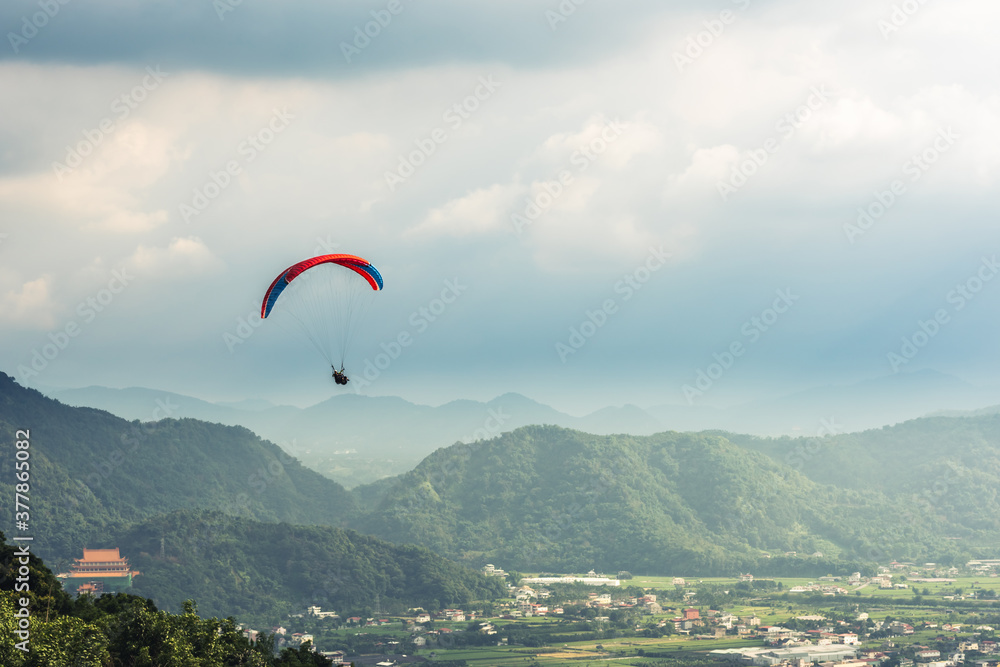 colorful paragliding over blue sky at town colorful paragliding over blue sky at town