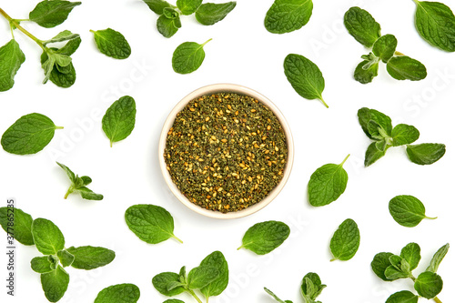 Middle Eastern zaatar spices with fresh zaatar leaves . Top view with copy space photo