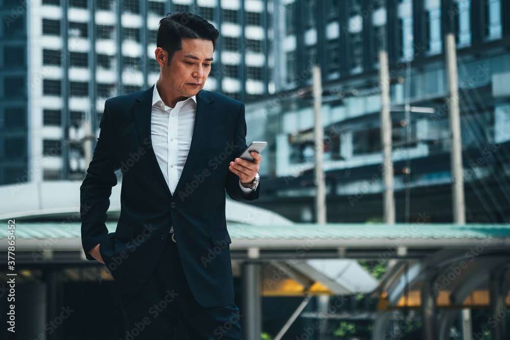 Business man using phone outside stock photo Business man using phone outside stock photo