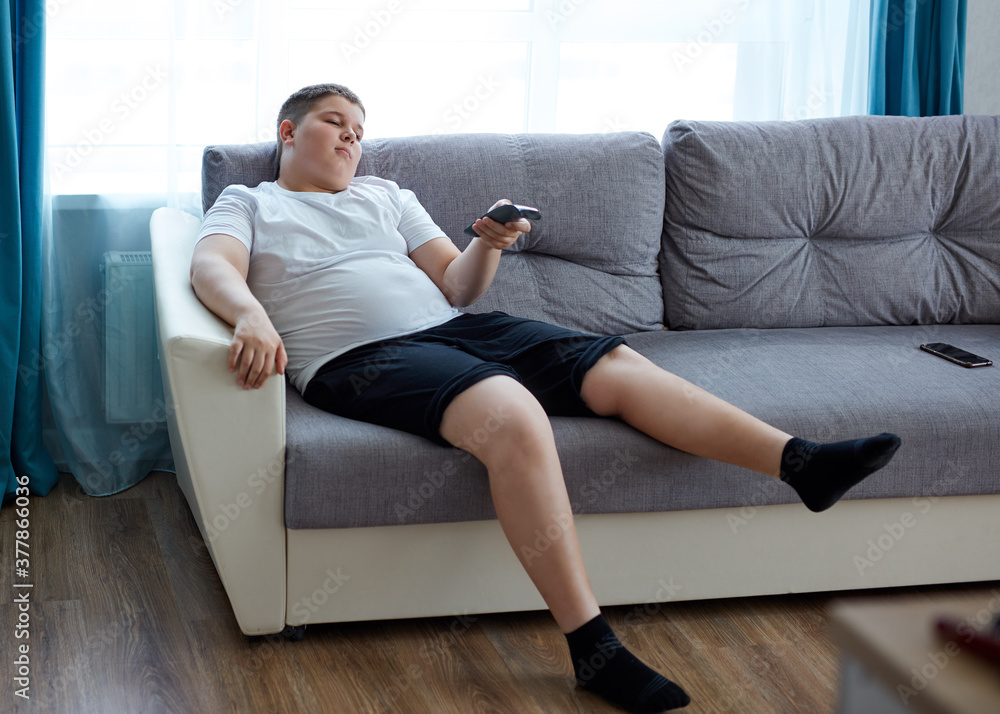 lazy child boy sit watching tv at home, passive overweight teenager spend time doing nothing lazy child boy sit watching tv at home, passive overweight teenager spend time doing nothing
