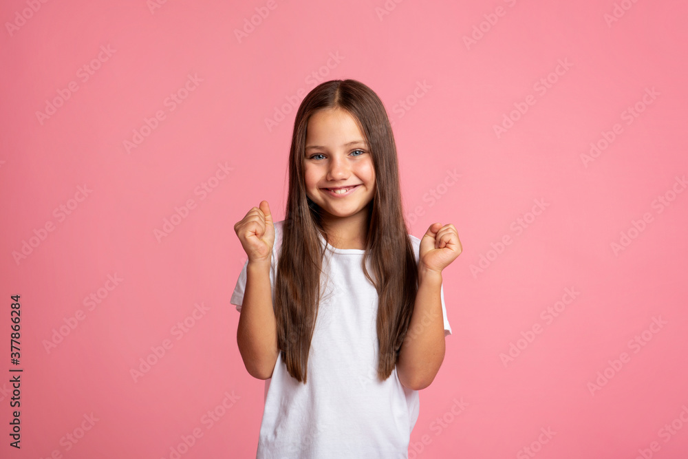 Fun and euphoria concept. Happy girl clenching fists Fun and euphoria concept. Happy girl clenching fists