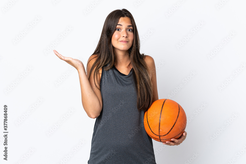 Young brazilian woman playing basketball isolated on white background having doubts while raising hands Young brazilian woman playing basketball isolated on white background having doubts while raising hands
