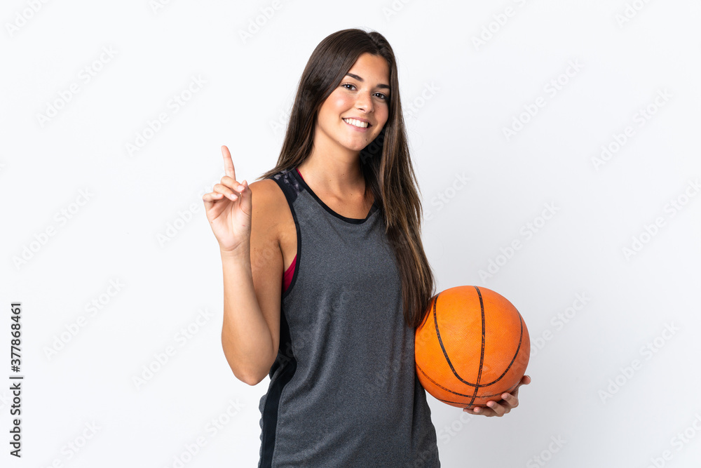 Young brazilian woman playing basketball isolated on white background pointing up a great idea Young brazilian woman playing basketball isolated on white background pointing up a great idea