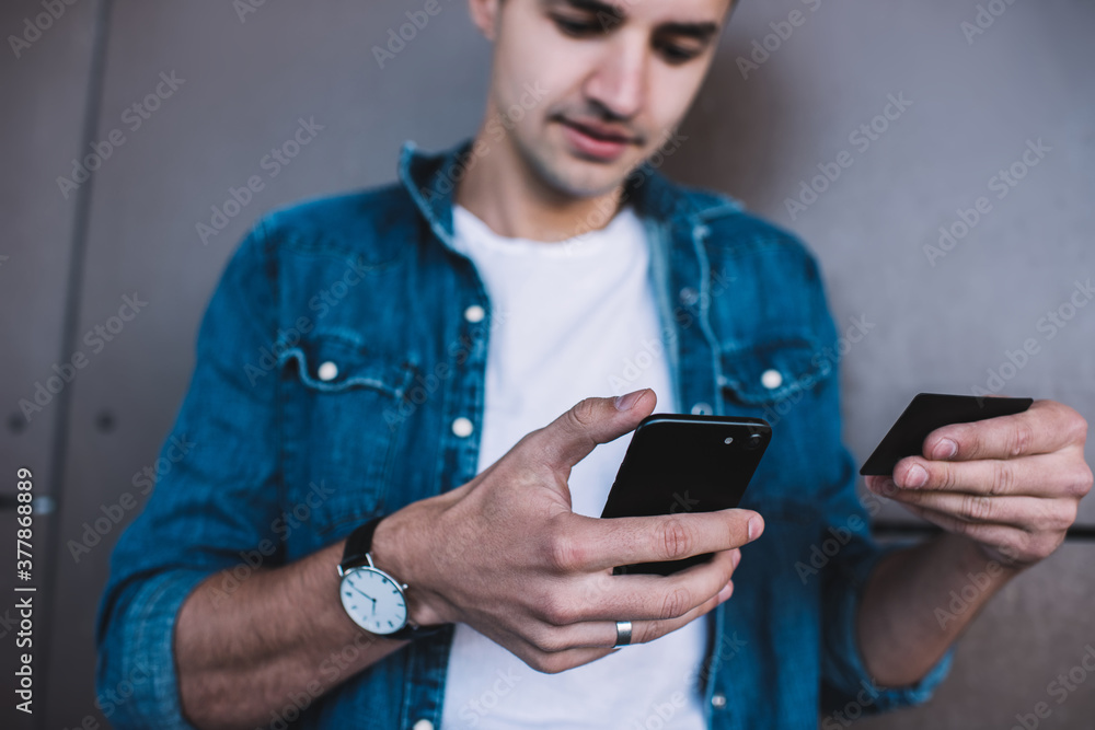 Man paying with credit card via smartphone Man paying with credit card via smartphone
