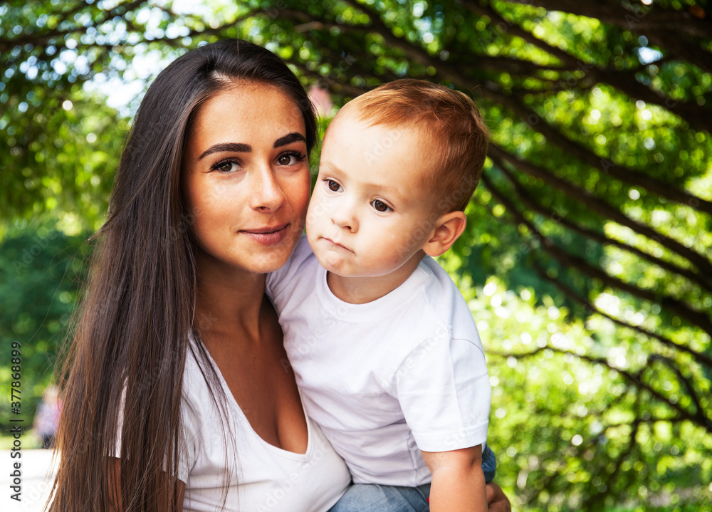 young pretty brunette mother with little cute boy walking in park happy smiling, lifestyle people concept young pretty brunette mother with little cute boy walking in park happy smiling, lifestyle people concept