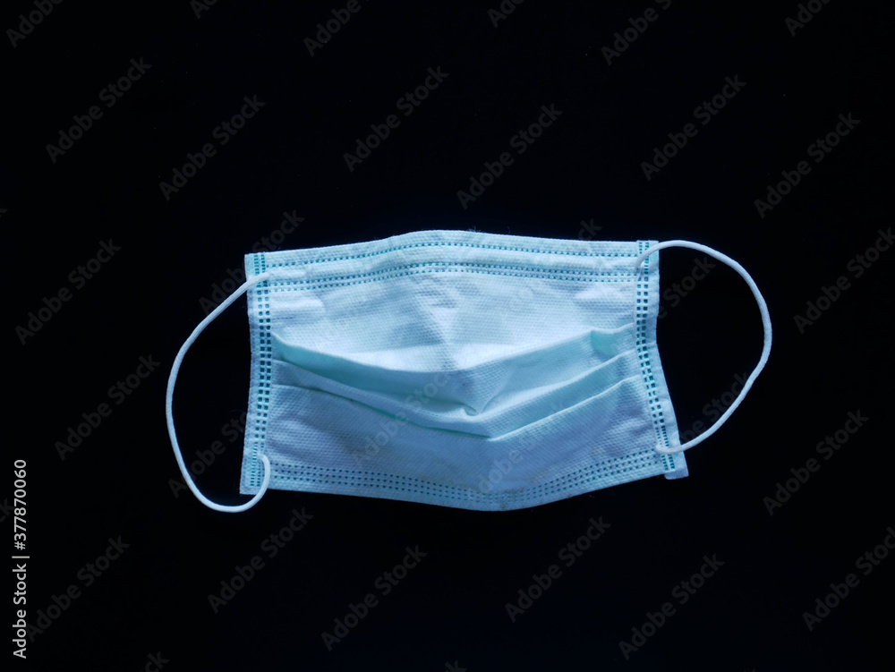 Used face mask Was left on the floor. concept corona virus and medical mask Used face mask Was left on the floor. concept corona virus and medical mask