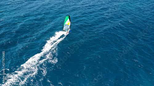 Aerial drone photo of wind surfer in open ocean deep blue sea on a windy morning