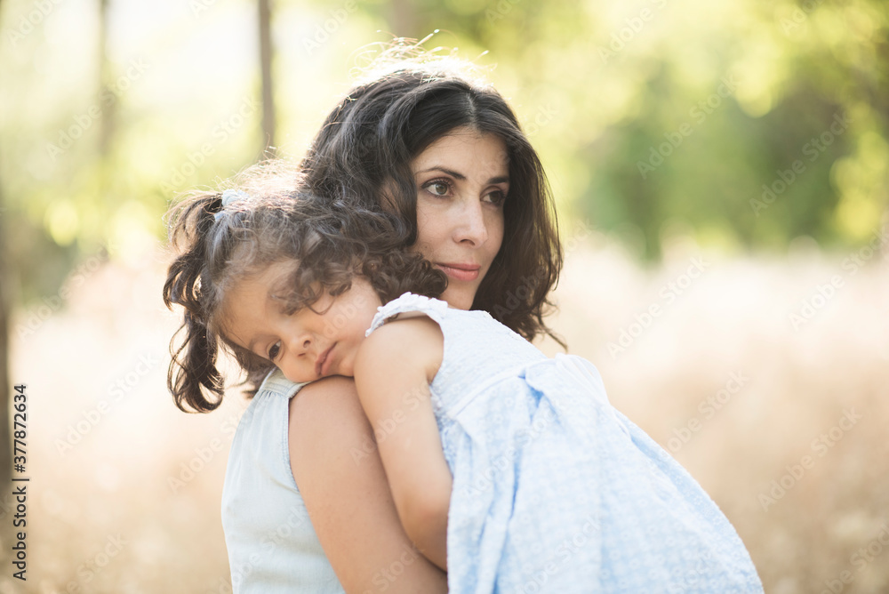 Naklejka premium Woman with daughter in outdoors image. Sad daughter