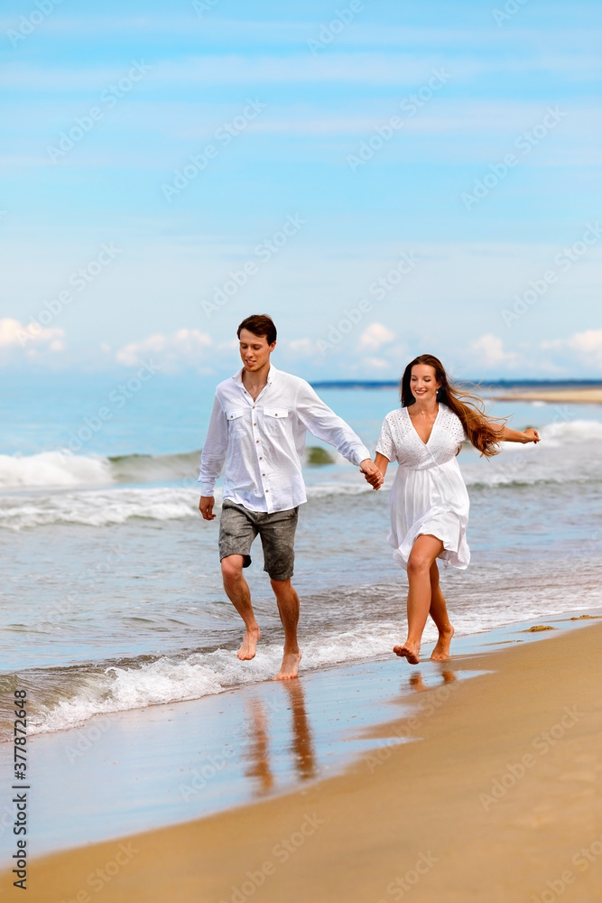 Nice couple of young people in love have fun on the sea coast Nice couple of young people in love have fun on the sea coast