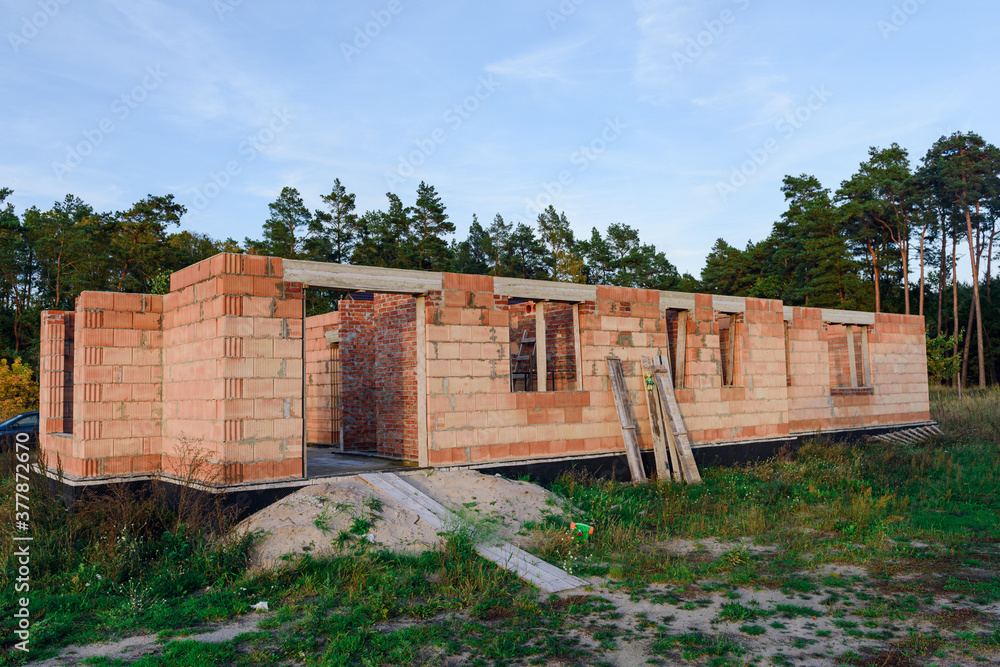 Exterior of a Unfinished Red Brick House Walls under Construction without Roofing