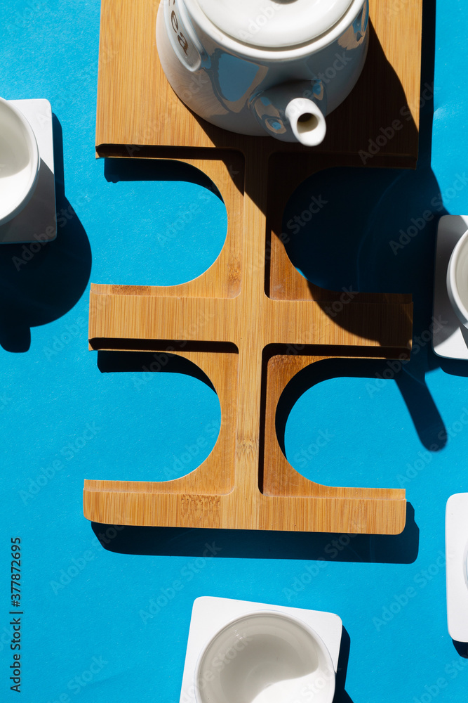 Tea cups set on blue background. Minimalist breakfast photo. Tea cups set on blue background. Minimalist breakfast photo.