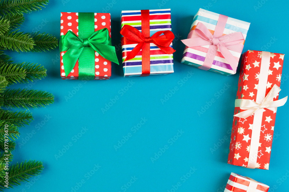Obraz premium Top view of colorful holiday background made of fir tree and gift box. Happy New Year concept with copy space