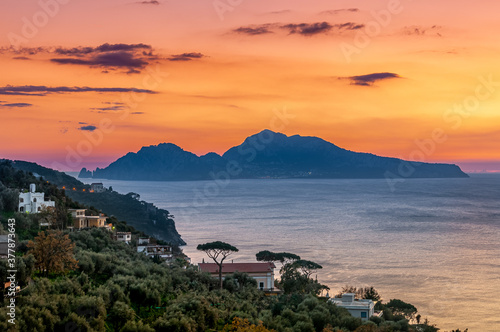 Massa Lubrense, Italy. January 12th, 2011. Breathtaking sunset on the island of Capri. The coast of Massa Lubrense in foreground.